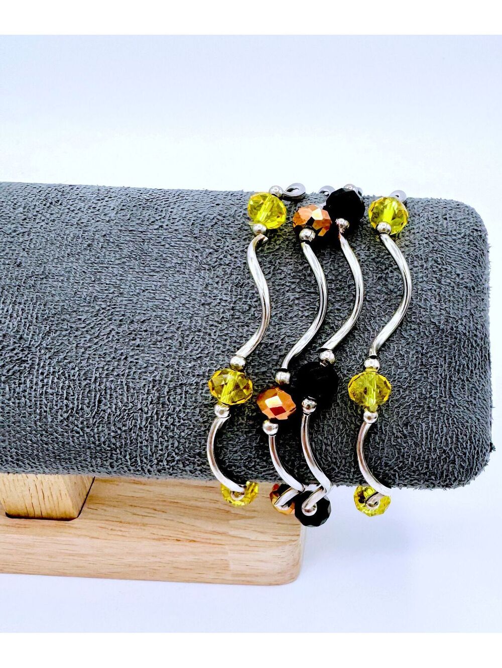 Twisted silver bugle - 2 yellow, 1 black and 1 burgundy crystals stretchy